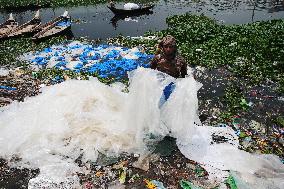 Workers collects polythene in Dhaka