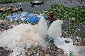 Workers collects polythene in Dhaka