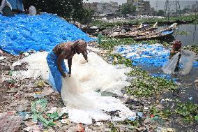 Workers collects polythene in Dhaka