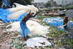 Workers collects polythene in Dhaka