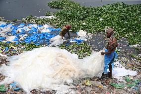 Workers collects polythene in Dhaka