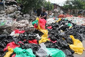 Workers collects polythene in Dhaka