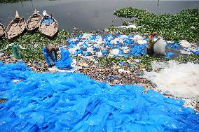 Workers collects polythene in Dhaka