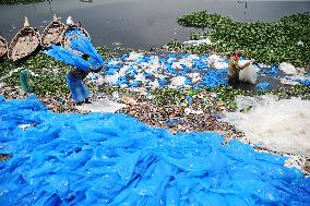 Workers collects polythene in Dhaka