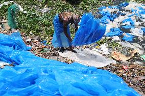 Workers collects polythene in Dhaka