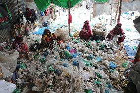 Workers collects polythene in Dhaka