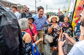 Justin Trudeau greets people as rain falls at Manila festival in Toronto