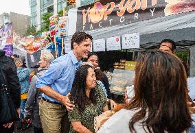 Justin Trudeau greets people as rain falls at Manila festival in Toronto