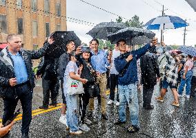 Justin Trudeau greets people as rain falls at Manila festival in Toronto