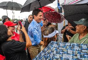 Justin Trudeau greets people as rain falls at Manila festival in Toronto