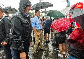 Justin Trudeau greets people as rain falls at Manila festival in Toronto