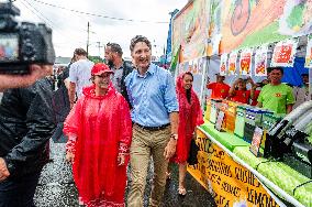 Justin Trudeau greets people as rain falls at Manila festival in Toronto