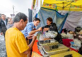 Justin Trudeau greets people as rain falls at Manila festival in Toronto