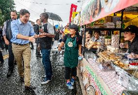 Justin Trudeau greets people as rain falls at Manila festival in Toronto