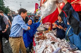 Justin Trudeau greets people as rain falls at Manila festival in Toronto