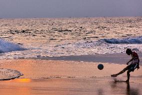 Youth Play A Game Of Football By The Ocean At Sunset In Paruthiyoor