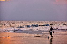 Youth Play A Game Of Football By The Ocean At Sunset In Paruthiyoor