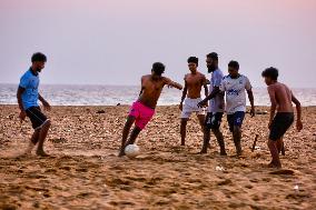 Youth Play A Game Of Football By The Ocean At Sunset In Paruthiyoor