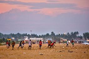 Youth Play A Game Of Football By The Ocean At Sunset In Paruthiyoor