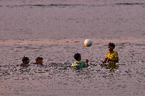 Youth Play A Game Of Football By The Ocean At Sunset In Paruthiyoor