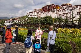 Tourists Visit The Potala Palace in Lhasa