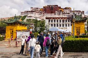 Tourists Visit The Potala Palace in Lhasa