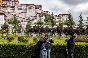 Tourists Visit The Potala Palace in Lhasa