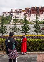 Tourists Visit The Potala Palace in Lhasa