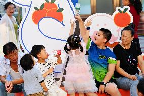 Tourists Visit Wangfujing Pedestrian Street in Beijing