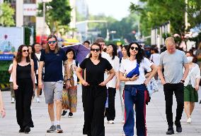 Tourists Visit Wangfujing Pedestrian Street in Beijing