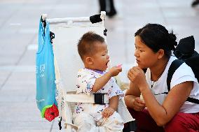 Tourists Visit Wangfujing Pedestrian Street in Beijing