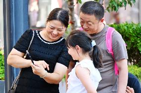 Tourists Visit Wangfujing Pedestrian Street in Beijing