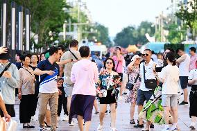 Tourists Visit Wangfujing Pedestrian Street in Beijing