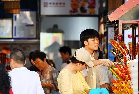 Tourists Visit Wangfujing Pedestrian Street in Beijing