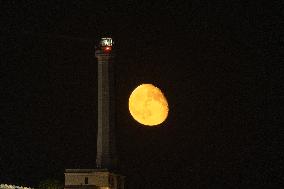 Waxing Gibbous Moon Rises Above The Lighthouse Of Santa Maria di Leuca