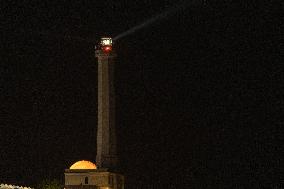 Waxing Gibbous Moon Rises Above The Lighthouse Of Santa Maria di Leuca