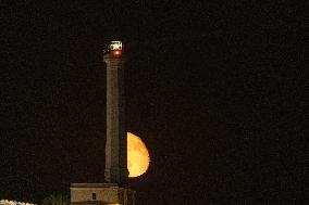 Waxing Gibbous Moon Rises Above The Lighthouse Of Santa Maria di Leuca