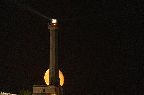 Waxing Gibbous Moon Rises Above The Lighthouse Of Santa Maria di Leuca