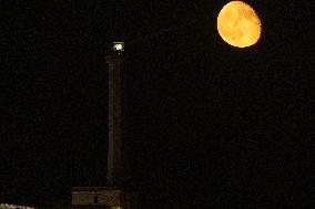 Waxing Gibbous Moon Rises Above The Lighthouse Of Santa Maria di Leuca