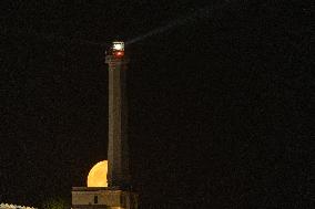 Waxing Gibbous Moon Rises Above The Lighthouse Of Santa Maria di Leuca