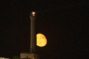 Waxing Gibbous Moon Rises Above The Lighthouse Of Santa Maria di Leuca