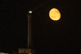 Waxing Gibbous Moon Rises Above The Lighthouse Of Santa Maria di Leuca