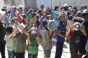 People Receive Food Aid In Jabalia Camp - Gaza