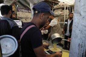 People Receive Food Aid In Jabalia Camp - Gaza