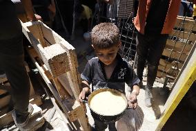 People Receive Food Aid In Jabalia Camp - Gaza