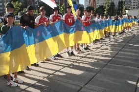 Run with Ukrainian flag in Kyiv