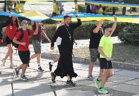 Run with Ukrainian flag in Kyiv