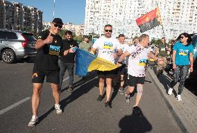 Run with Ukrainian flag in Kyiv