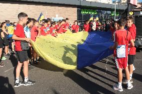 Run with Ukrainian flag in Kyiv