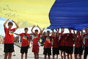 Run with Ukrainian flag in Kyiv